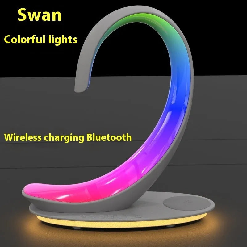 White swan-shaped desktop wireless charger with Bluetooth speaker and colourful atmosphere lighting