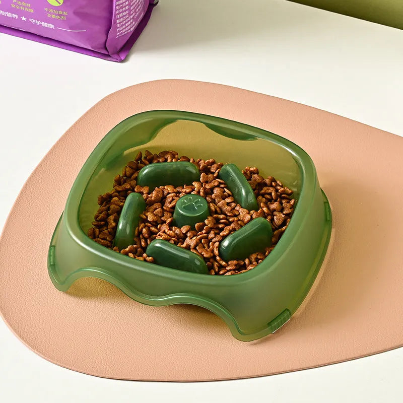 Blue plastic slow feeder dog bowl with raised internal maze pattern to prevent fast eating.