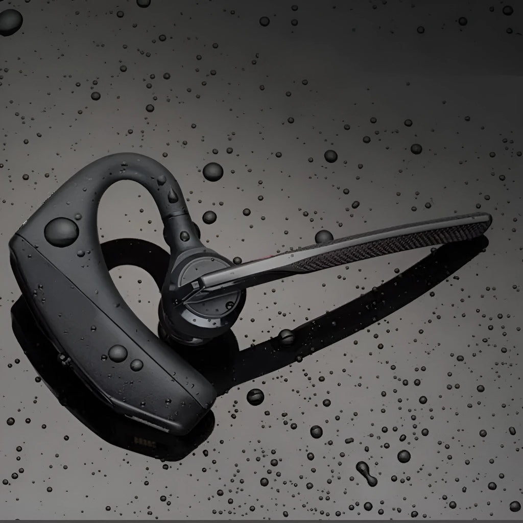 Black wireless sports headphones with a large battery and built-in microphone on a plain background.