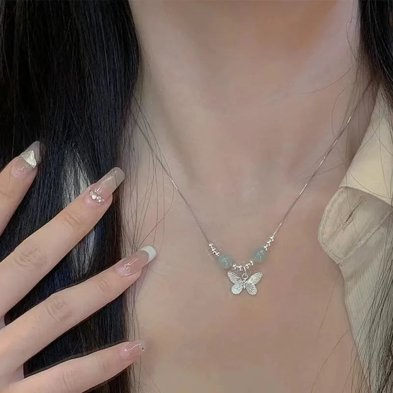 Silver butterfly jewellery set with hetian jade accents showing bracelet and necklace combination