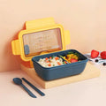 Green plastic bento lunch box with four food compartments showing Nordic design
