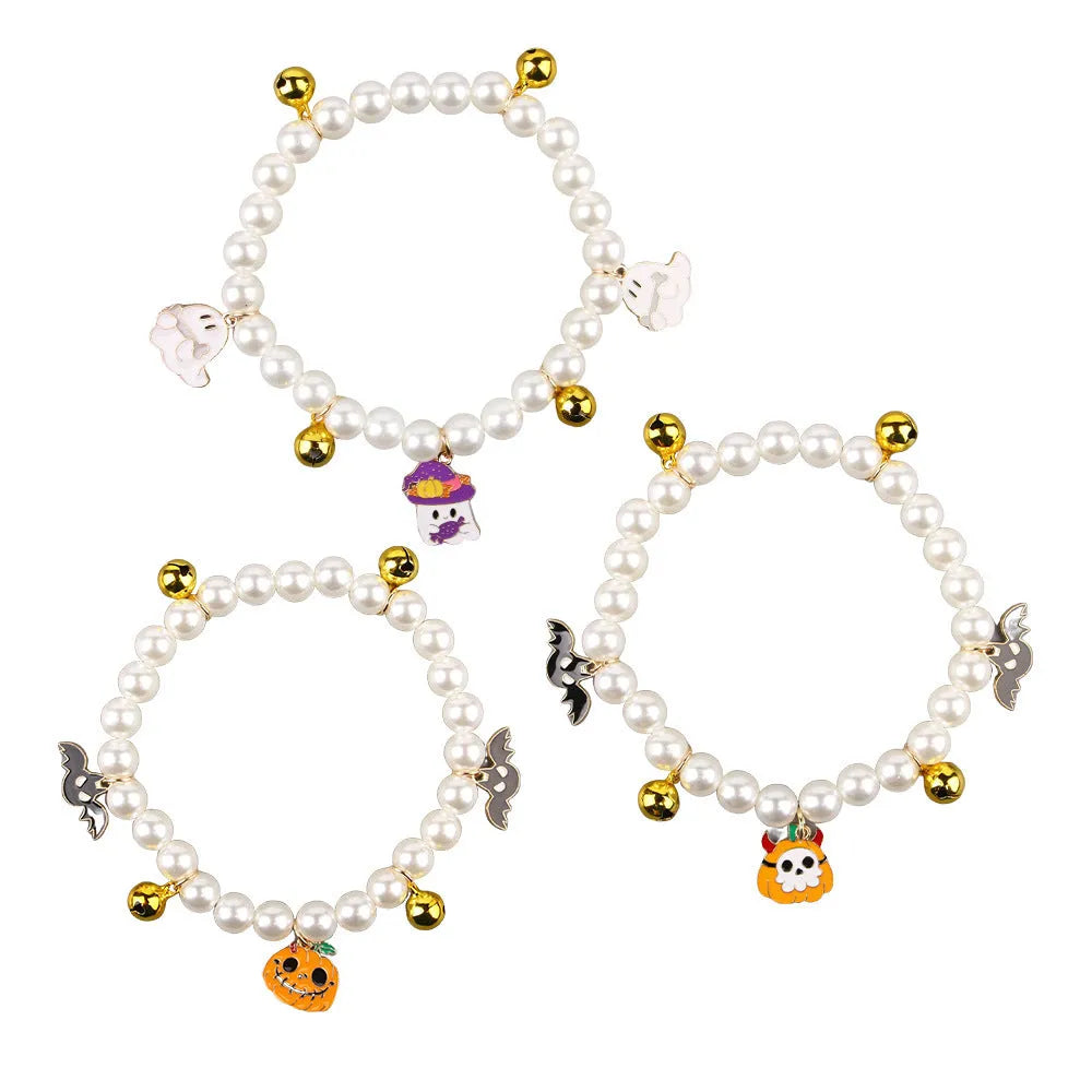 Simulated pearl Halloween cat collar with a choice of purple ghost, skull, or smiling pumpkin charm.