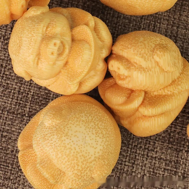 Small cute Fulu Pig bamboo carving ornament on a surface, showing its ingot shape.