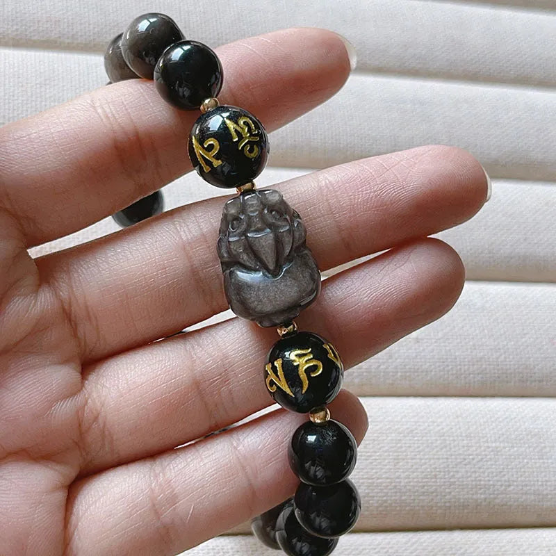 Men's silver stone beaded bracelet with zodiac and Chinese proverb charms on a wrist.