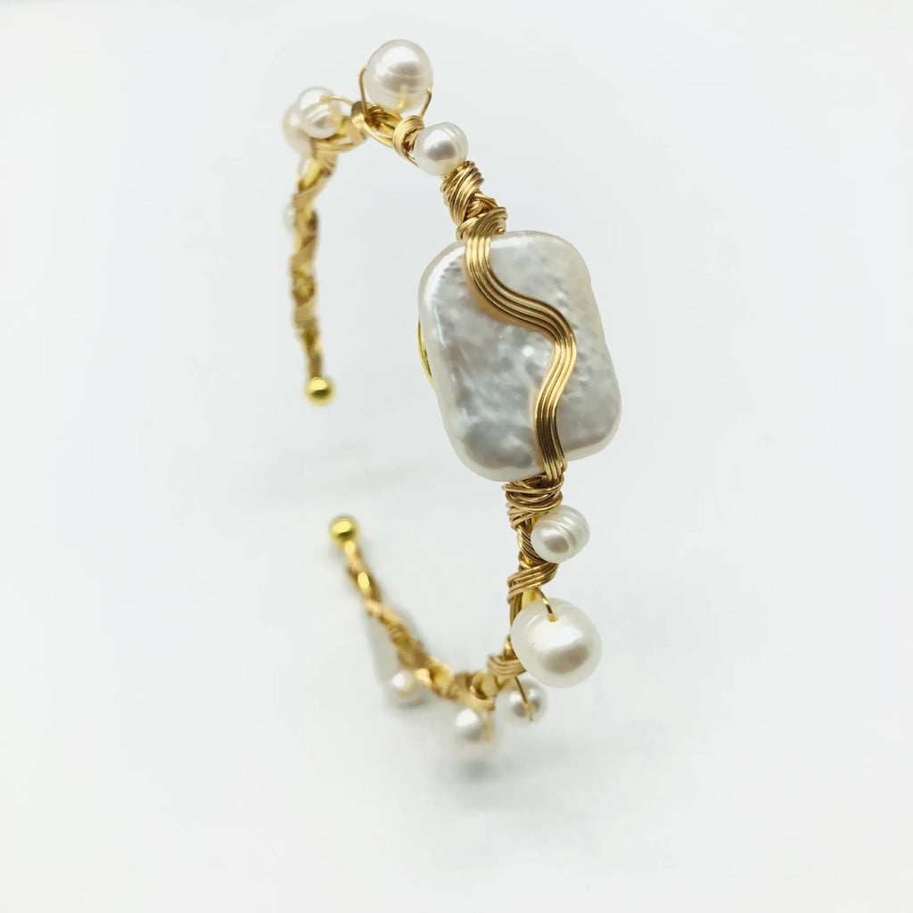 Natural freshwater pearl handmade wire-wrapped bracelet in gold titanium steel on wrist