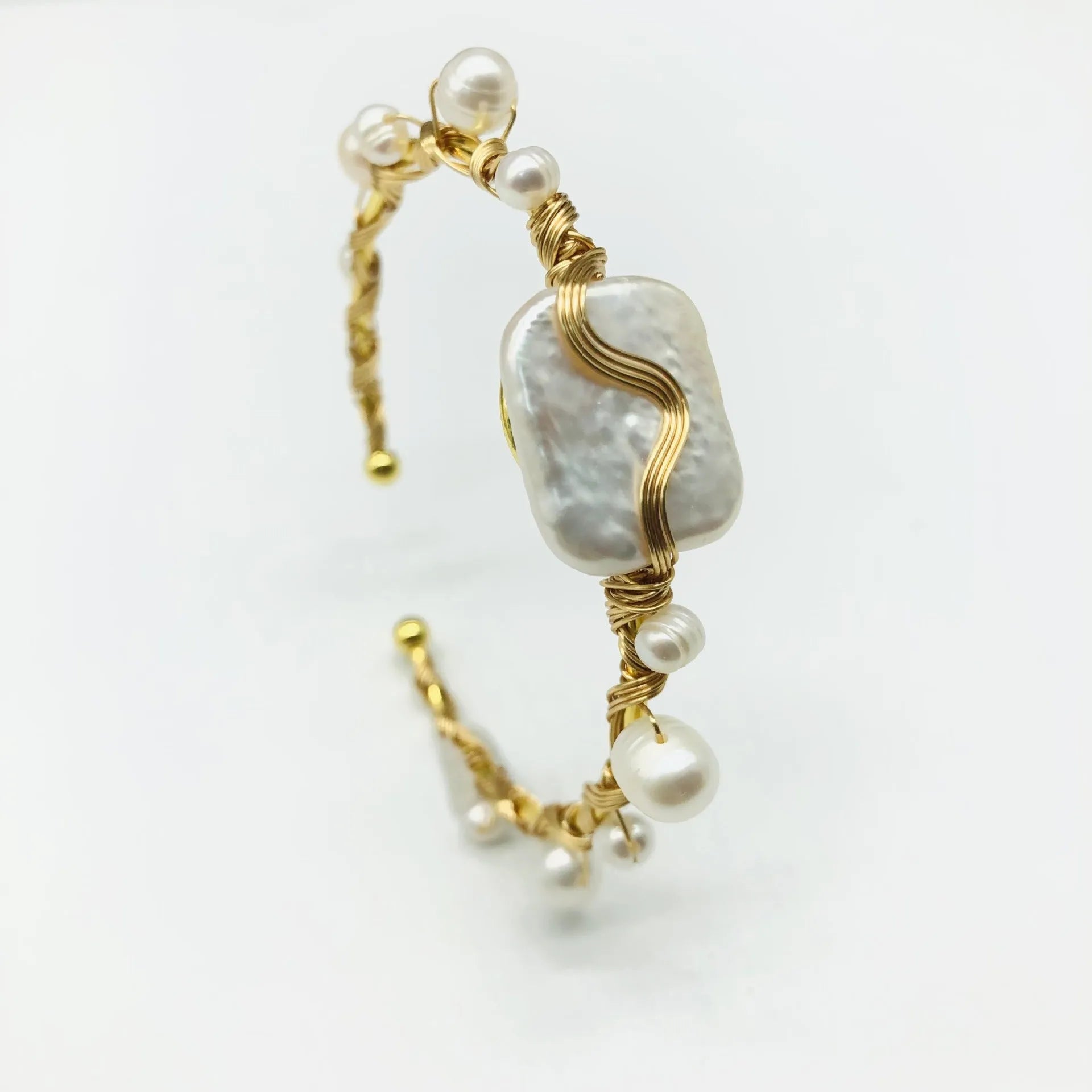 Natural freshwater pearl handmade wire-wrapped bracelet in gold titanium steel on wrist