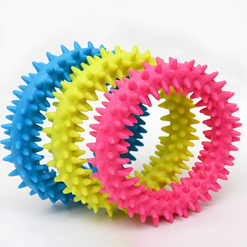 Blue TPR spiked ring dog chew toy for dental cleaning and bite training on a white background.