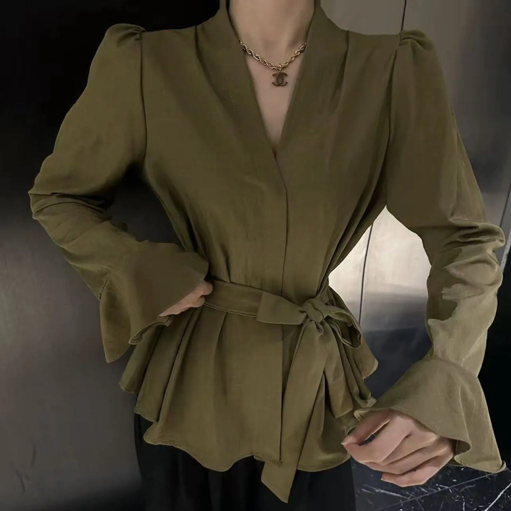 Women's black French-style shirt with irregular collar, tied front, and long flared bell sleeves