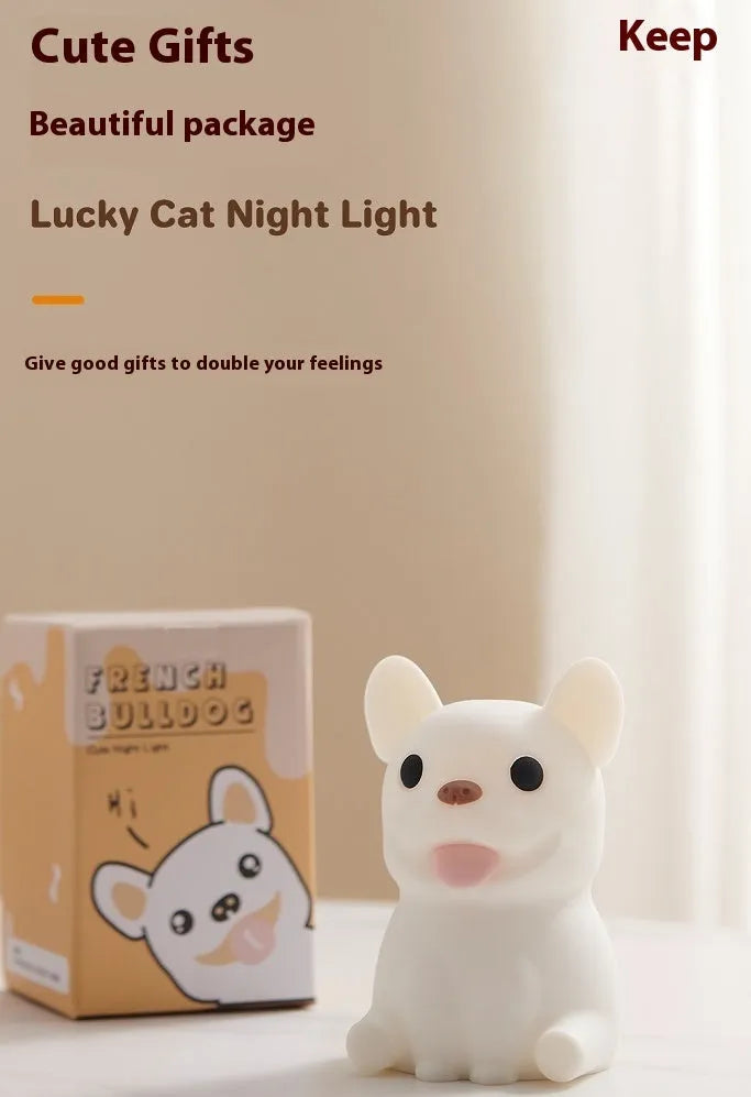 Silicone animal-shaped USB night light with touch dimming on a bedside table.