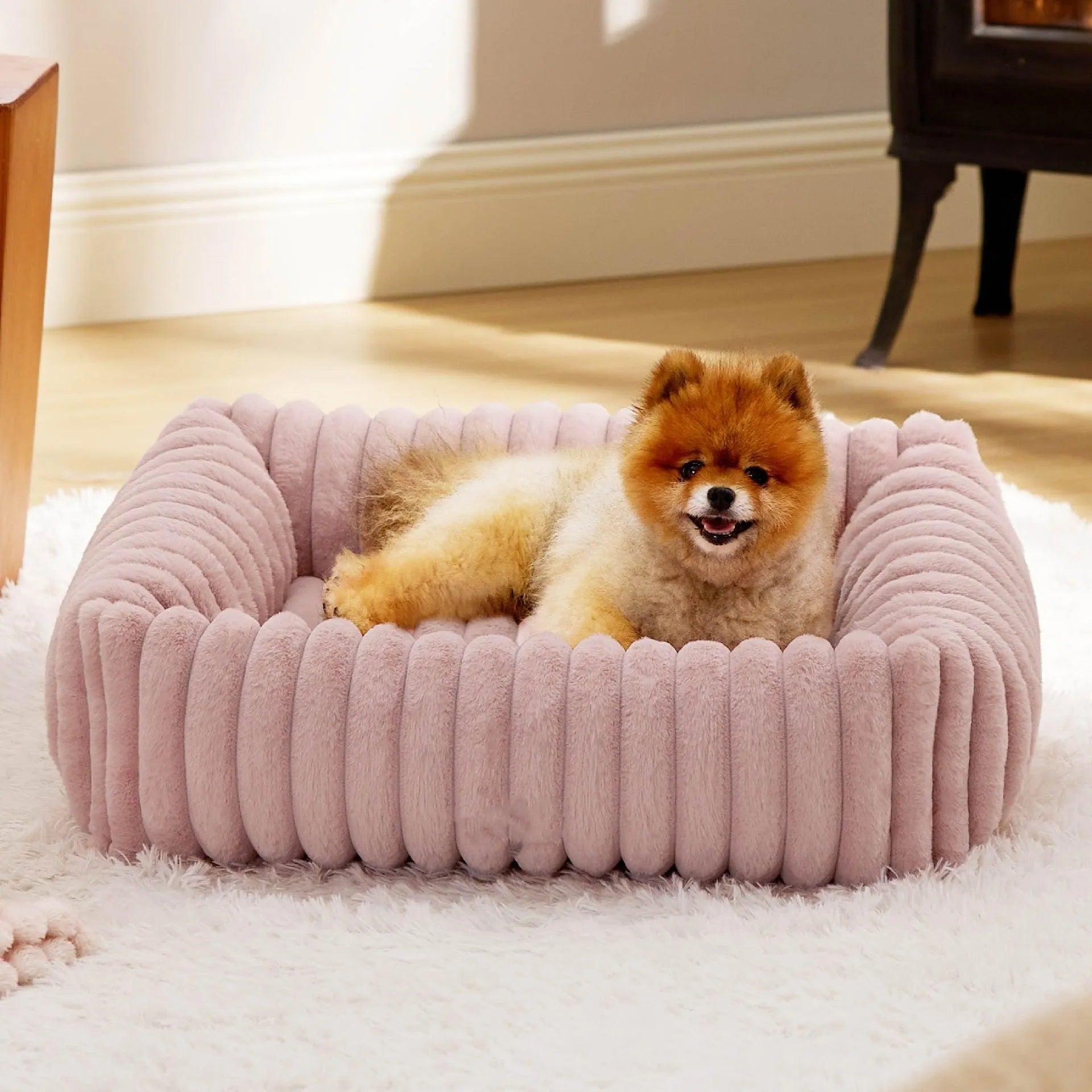 Beige removable cover pet bed for a medium-sized dog on a wooden floor.