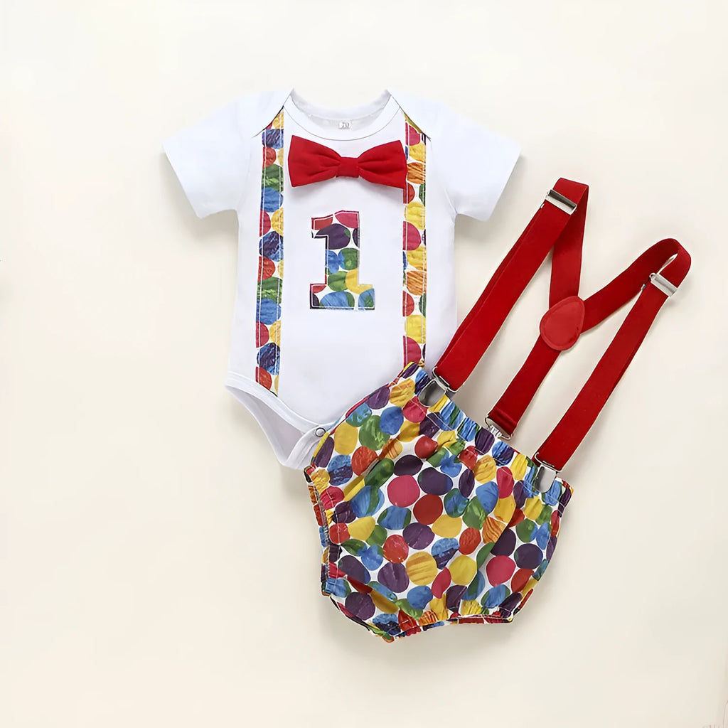 Baby wearing a blue cotton romper shorts with dinosaur print and straps.