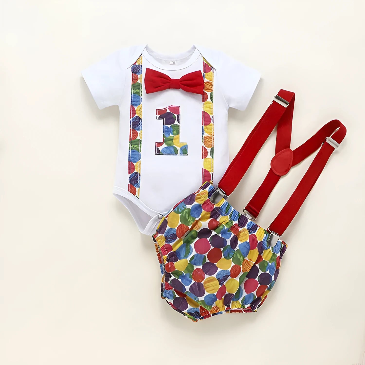 Baby wearing a blue cotton romper shorts with dinosaur print and straps.