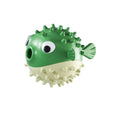 Green fish-shaped dog toy with treat dispensing opening and textured surface for dental cleaning