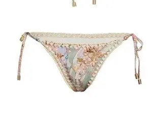 Women's beige floral bikini set with matching skirt on neutral background