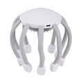 Black eight-claw electric head massager with USB cable on white background.