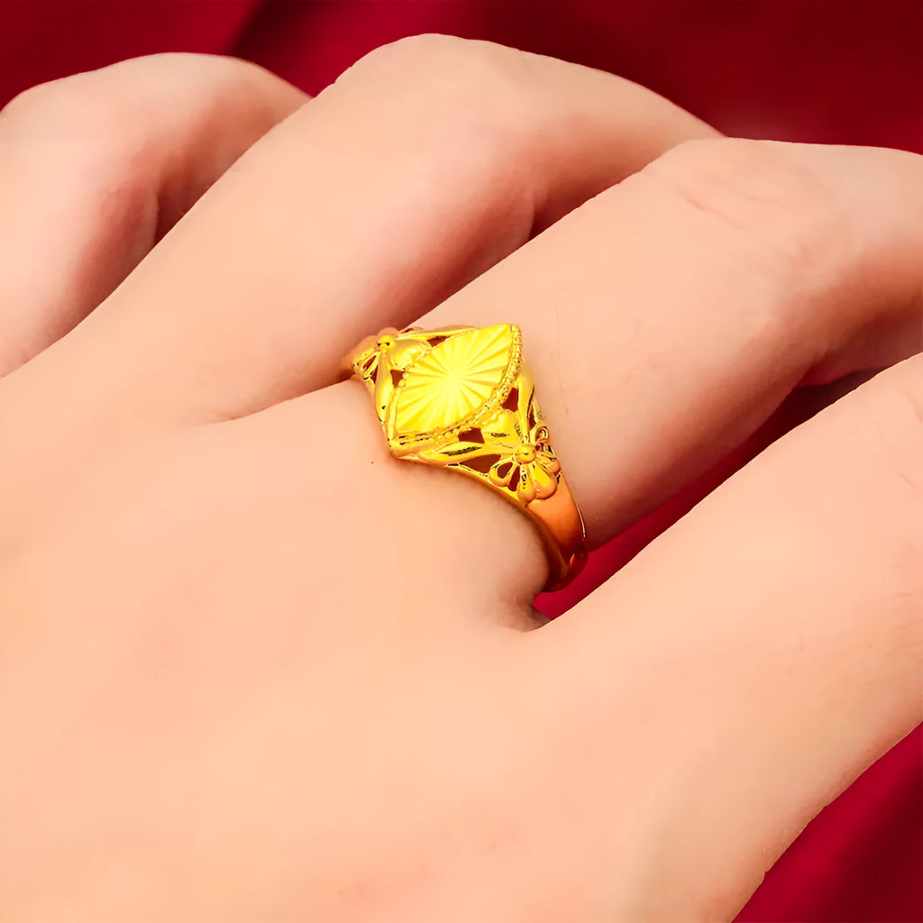 Gold openwork geometric flower ring with a textured alluvial pattern on a brass base.