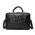 Brown vintage leather men's briefcase open to show internal laptop pocket and document organisers.