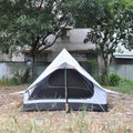 Brown A-line hiking tent erected with hiking poles showing spacious interior for 2-3 people