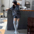 Women's creamy-white cable knit sweater and shorts set with a geometric pattern.