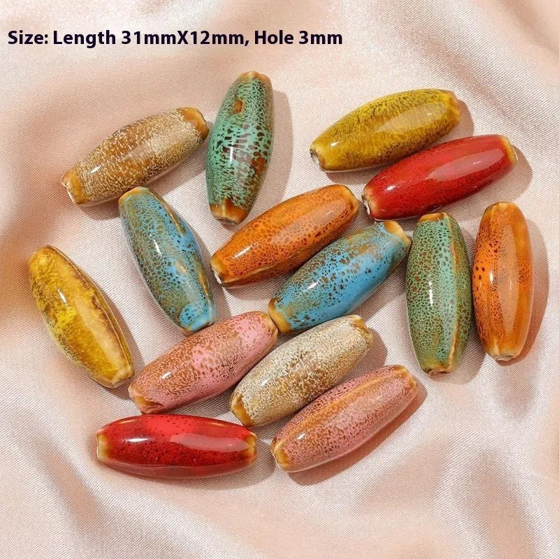 Assortment of ceramic bullet beads in flower glaze colours for jewellery making