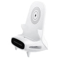 White wireless charging phone stand on a desk, charging a mobile phone at a viewing angle.