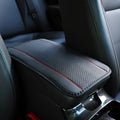 Black embossed PU leather car armrest box mat measuring 32 by 19 centimetres.