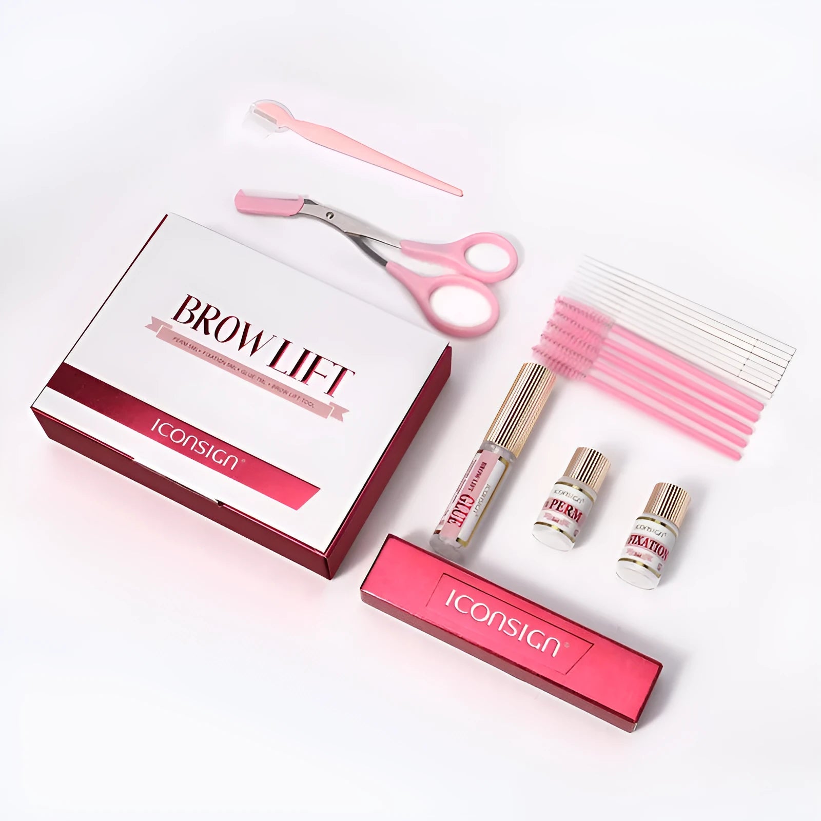 Pink eyebrow quick ironing tool inside a complete eyebrow perm suit set for home grooming.