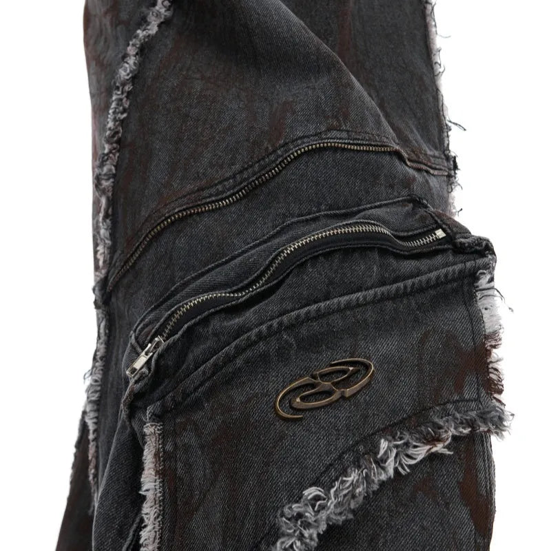 Black gradient distressed denim coat with padded shoulders and matching trousers, featuring raw edges and splash-dye finish.