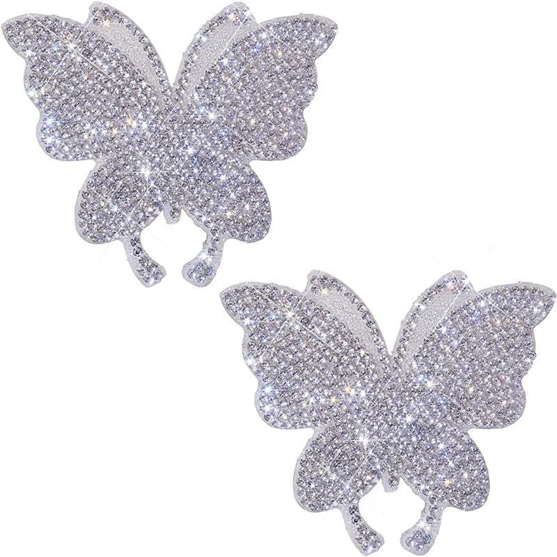 Close-up of a diamond-encrusted bear paw and butterfly design on a 7x6cm glass car sticker.