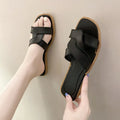 Women's PVC flip flop slippers with a cross strap and toe ring in a solid colour.