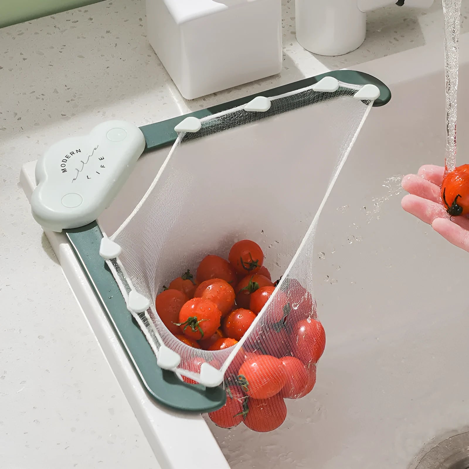 Triangular grey sink drain rack with mesh filter bag in kitchen sink corner