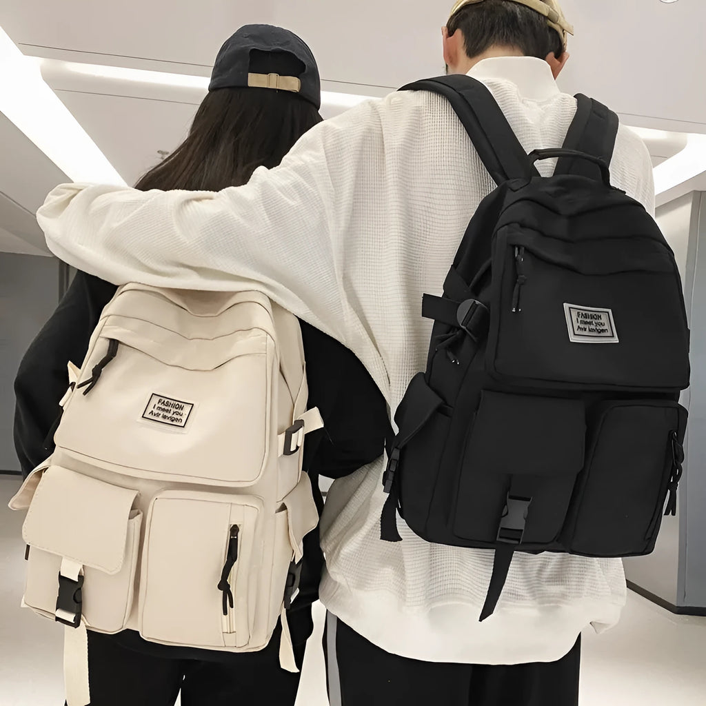 Black and white nylon student backpack with front pockets and laptop compartment.