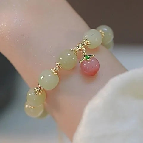 Handcrafted glass peace buckle bracelet with coloured glaze rabbit design on a white background.
