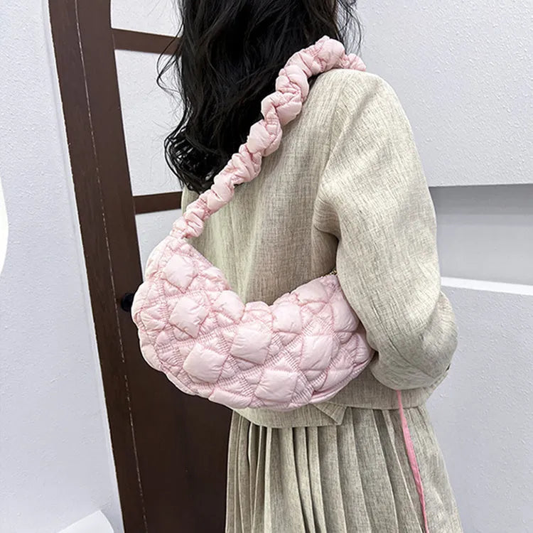 Women's solid colour nylon messenger bag with long shoulder strap shown in beige.