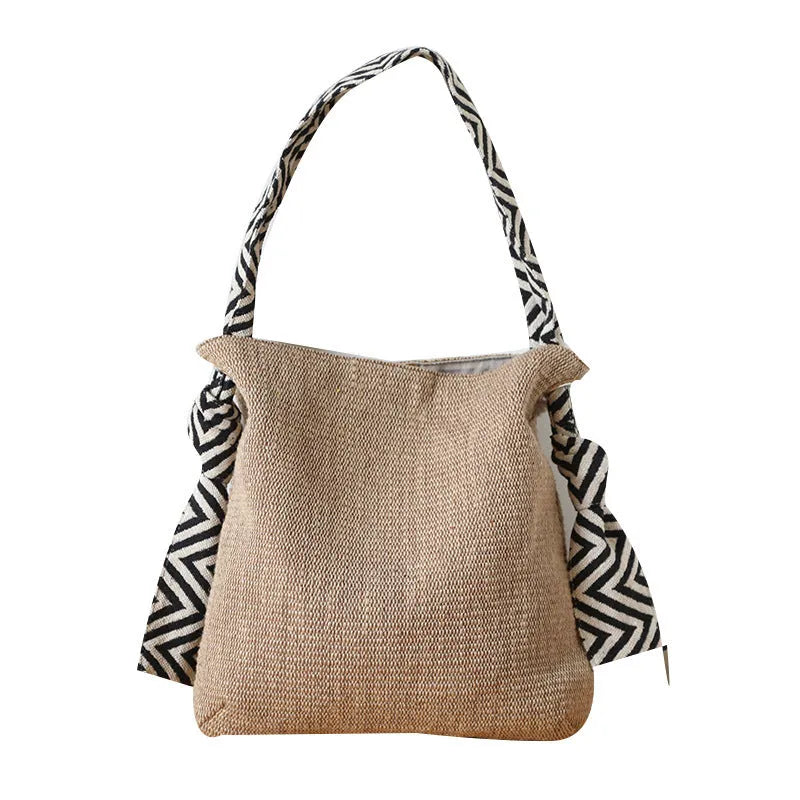 Khaki one-shoulder polyester canvas tote bag with cotton lining, magnetic closure, and internal pockets on a plain background