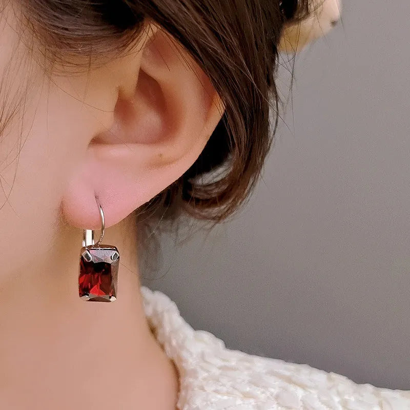 Women's square crystal earrings in red, yellow, and purple colours with copper construction