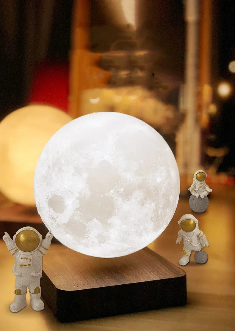 Maglev floating moon and planet night light with LED glow and small astronaut figures on base.