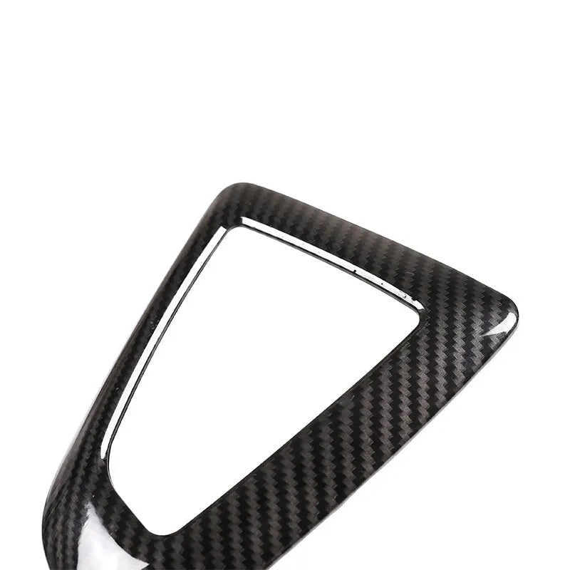 BMW gear base frame in left titanium colour with carbon fibre pattern, showing 3M adhesive backing.