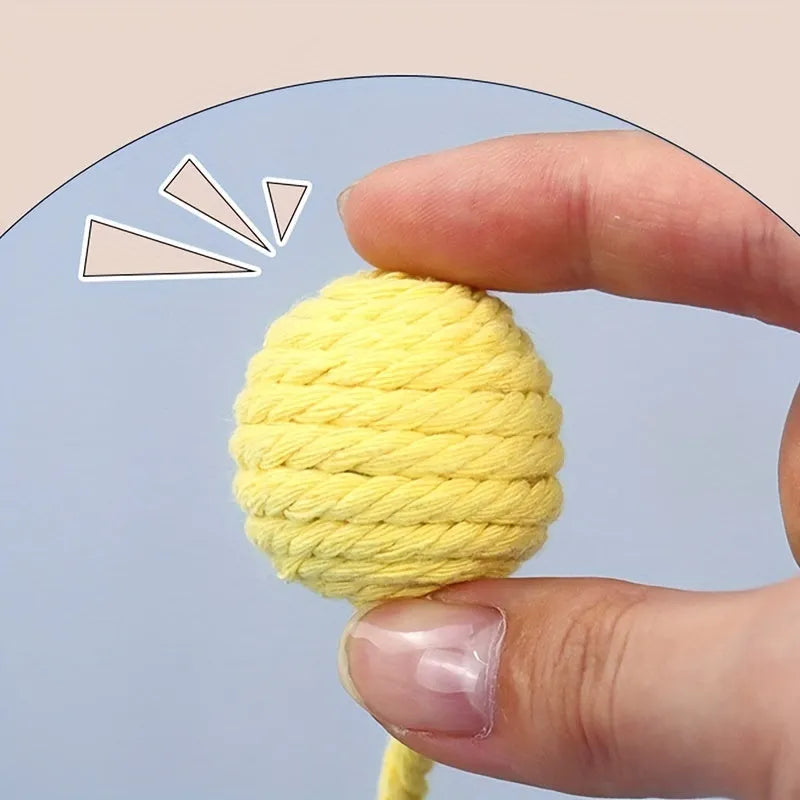 Colourful cat toy ball with rope attached and internal bell for kitten play stimulation