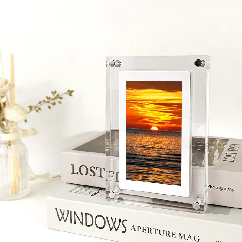 White acrylic digital picture frame showing family photos on a 5-inch vertical screen