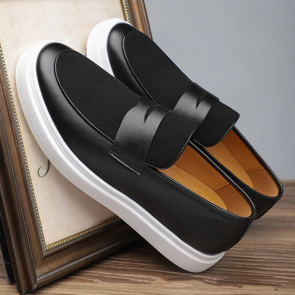 Black men's slip-on casual shoes with tassel detailing and Gommino soles