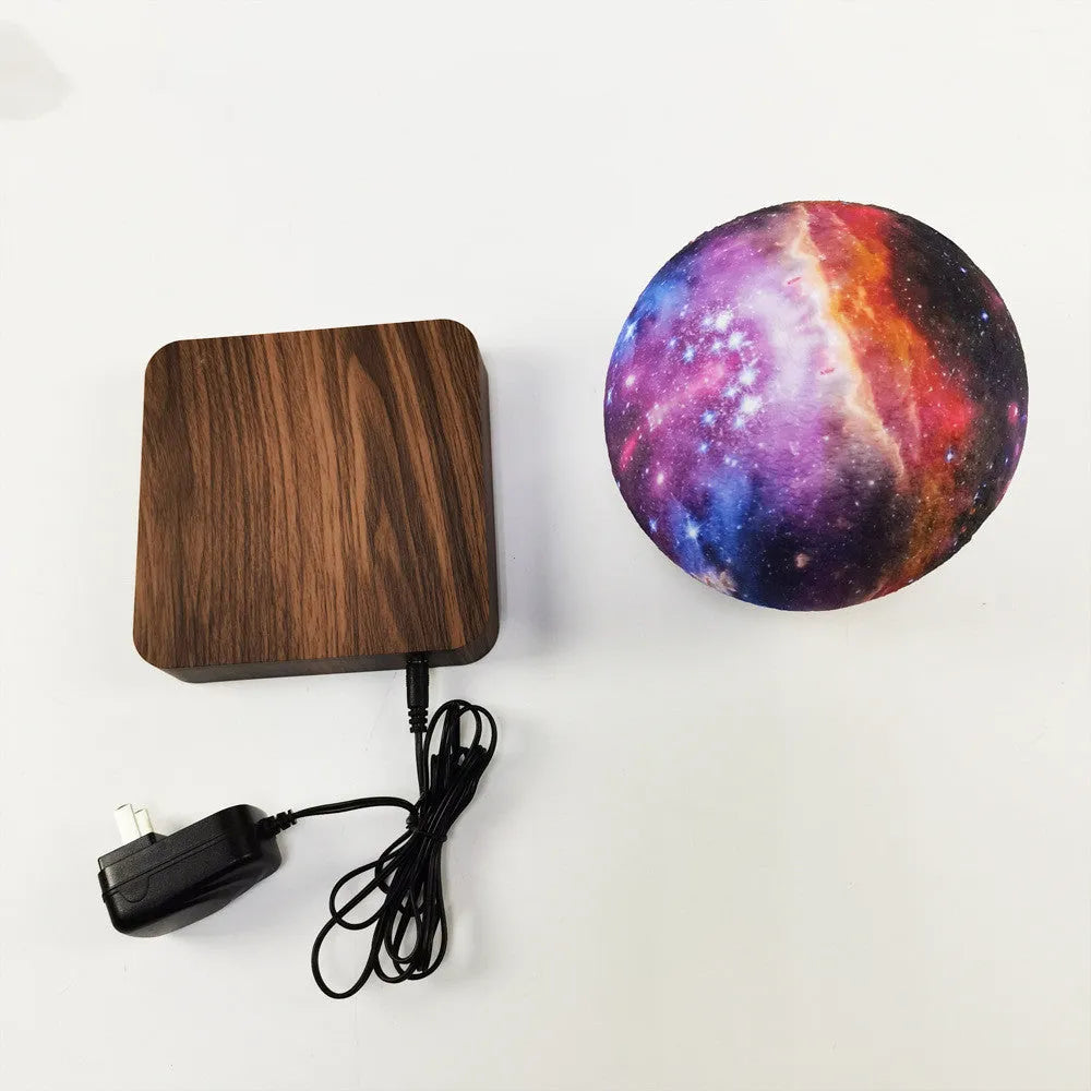 Magnetic levitation galaxy moon lamp floating above circular base with colourful lighting