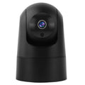 White indoor security camera with adjustable lens on a desk next to its power adapter.