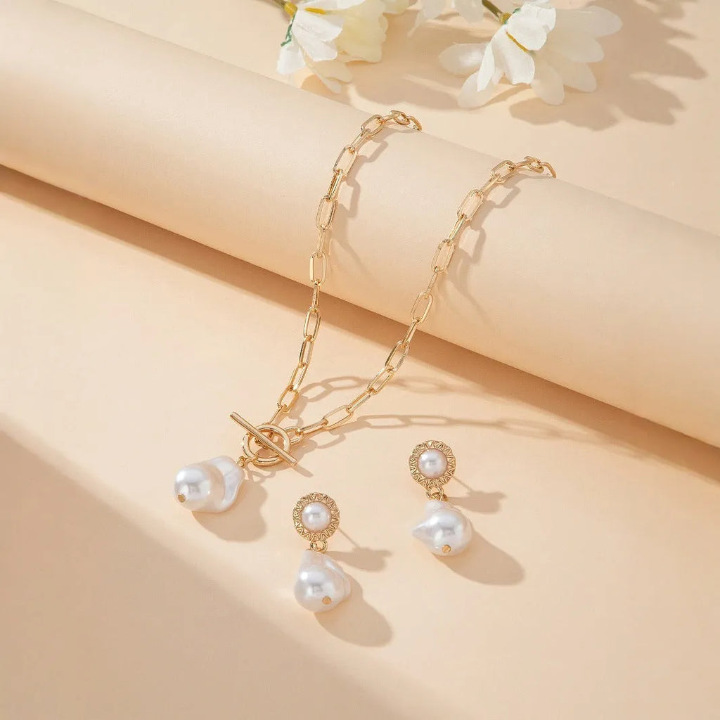 Gold colour baroque pearl necklace and earring set with retro design on dark background