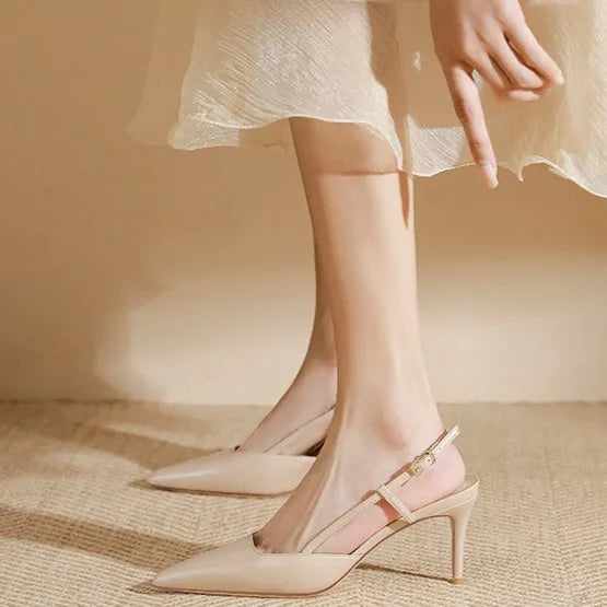 Apricot women's high-heeled sandals with a buckle toe strap and thin belts on a rubber sole.