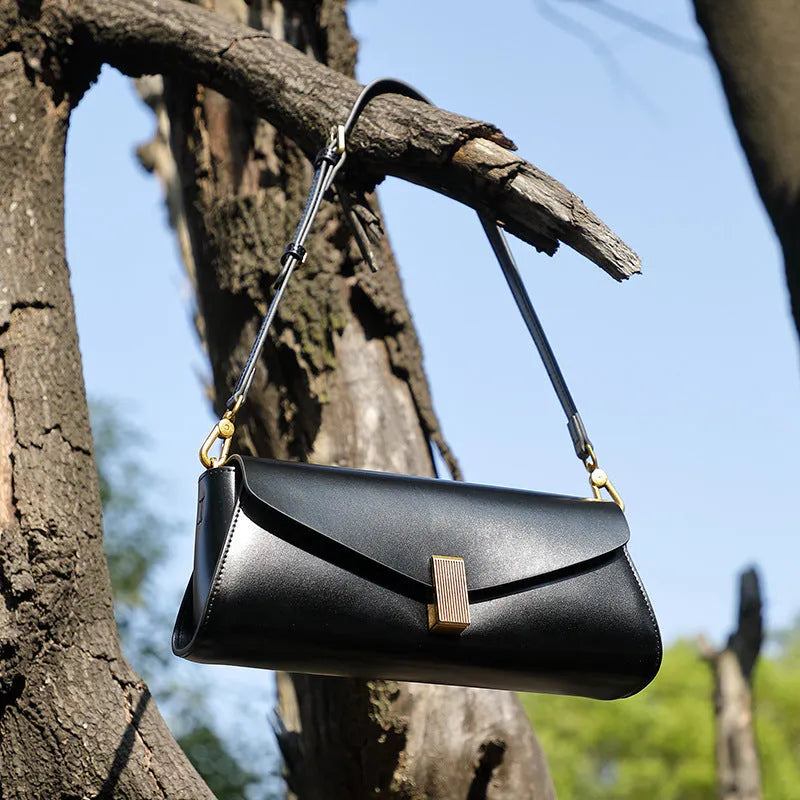 A pillow-shaped women's cowhide leather cross-body bag with a clamshell opening, shown in a choice of colours.