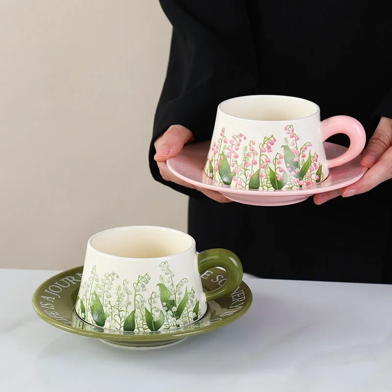 Ceramic coffee cup and saucer set with two cups, two saucers, and two spoons