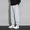 Men's loose fit grey cotton sports trousers with elastic waistband and drawstring closure