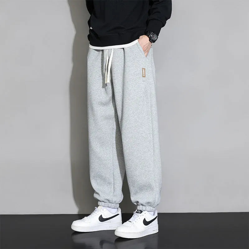 Men's loose fit grey cotton sports trousers with elastic waistband and drawstring closure
