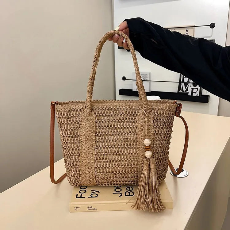 Large straw crossbody bag with woven raffia construction and polyester lining